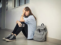 teen girl crying at school