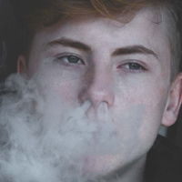 teen exhaling smoke through nose